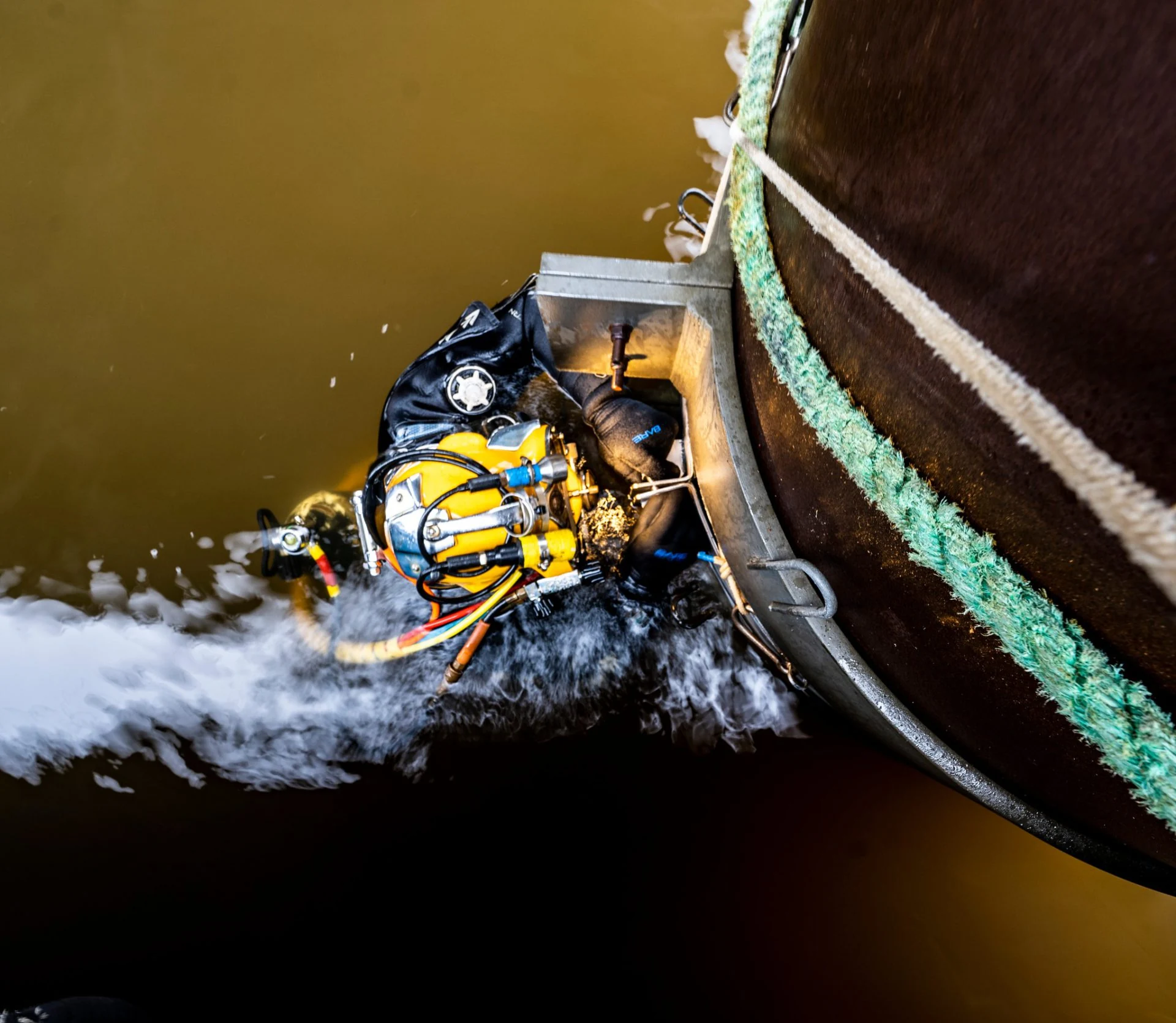 Nautilus Divers commercial diver alongside a vessel hull